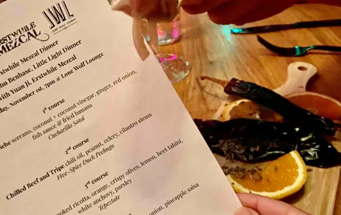 Mezcal food pairing menu from a dinner event hosted by Erstwhile Mezcal and Lone Wolf Lounge, featuring ceviche, grilled lettuce, beef, duck, and pineapple ice cream paired with premium mezcal.